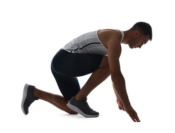 Photo of Sportsman in starting position for run on white background