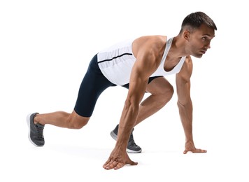 Photo of Sportsman in starting position for run on white background