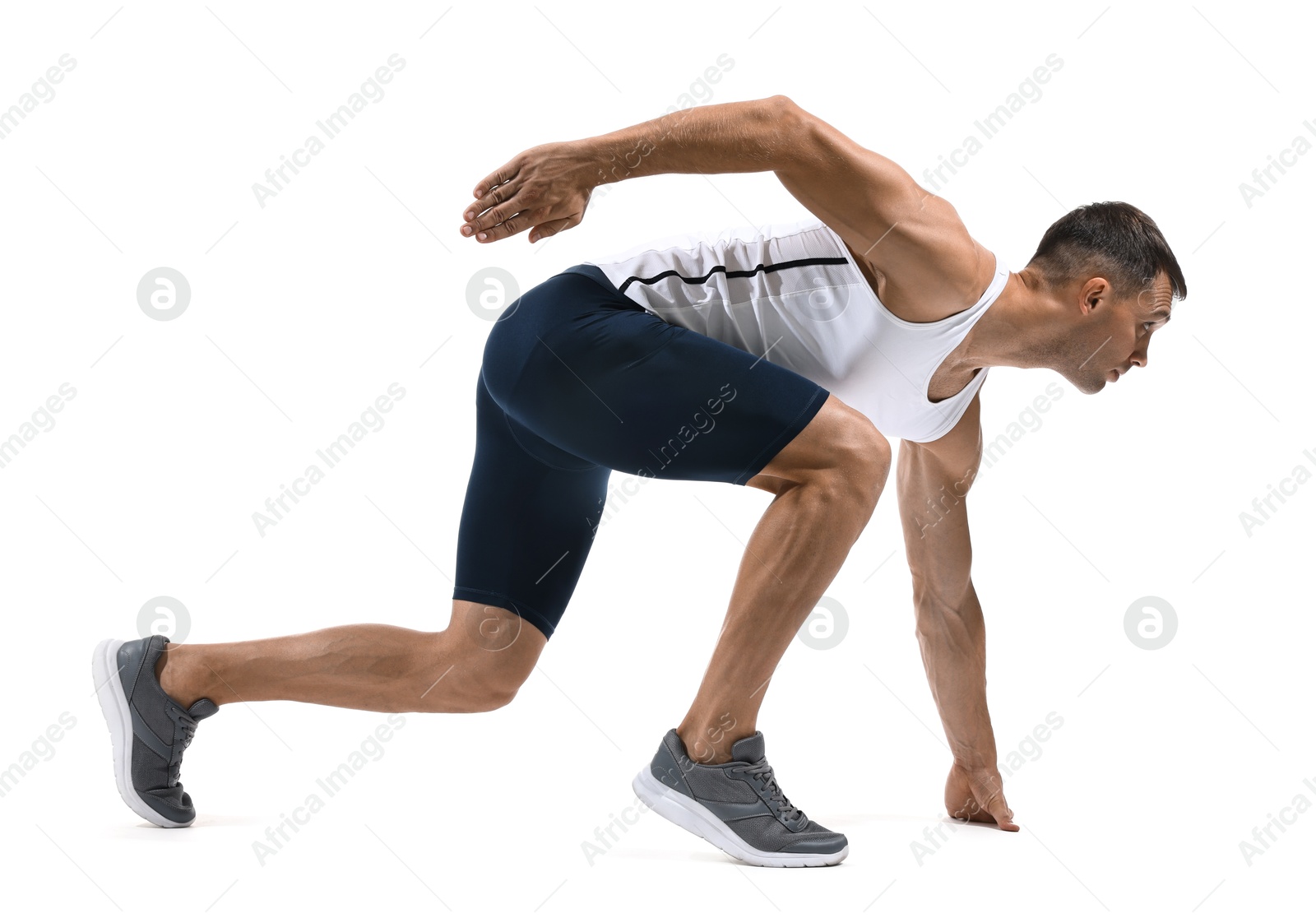 Photo of Sportsman in starting position for run on white background