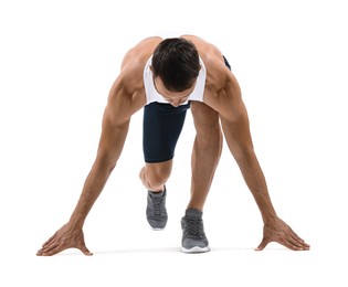 Sportsman in starting position for run on white background