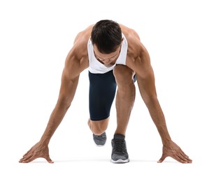 Photo of Sportsman in starting position for run on white background