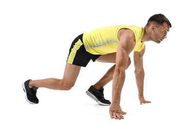 Photo of Sportsman in starting position for run on white background