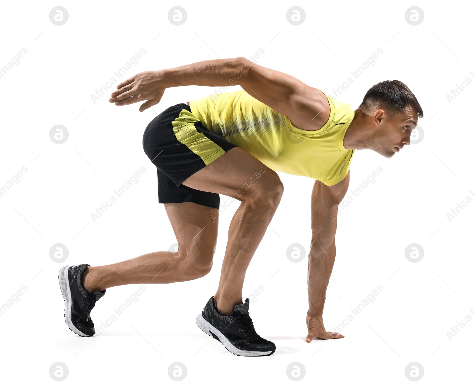 Photo of Sportsman in starting position for run on white background