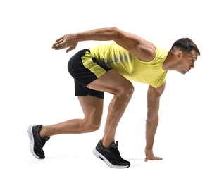 Sportsman in starting position for run on white background