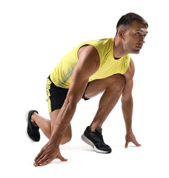 Sportsman in starting position for run on white background