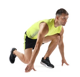 Photo of Sportsman in starting position for run on white background