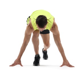 Photo of Sportsman in starting position for run on white background