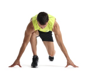 Sportsman in starting position for run on white background