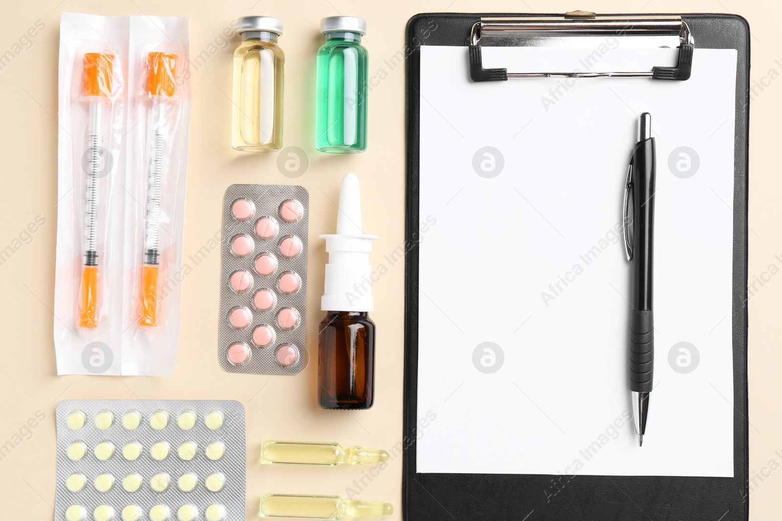 Photo of Pharmacist concept. Flat lay composition with clipboard and pills on beige background