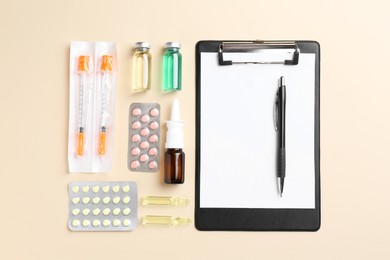 Photo of Pharmacist concept. Flat lay composition with clipboard and pills on beige background