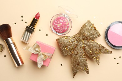 Flat lay composition with makeup products and Christmas decor on beige background