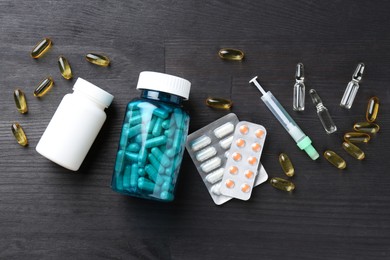 Photo of Pharmacist. Different pills, plastic bottles, syringe and ampoules on grey wooden table, flat lay