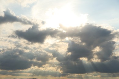 Photo of Sun shining through clouds on beautiful sky