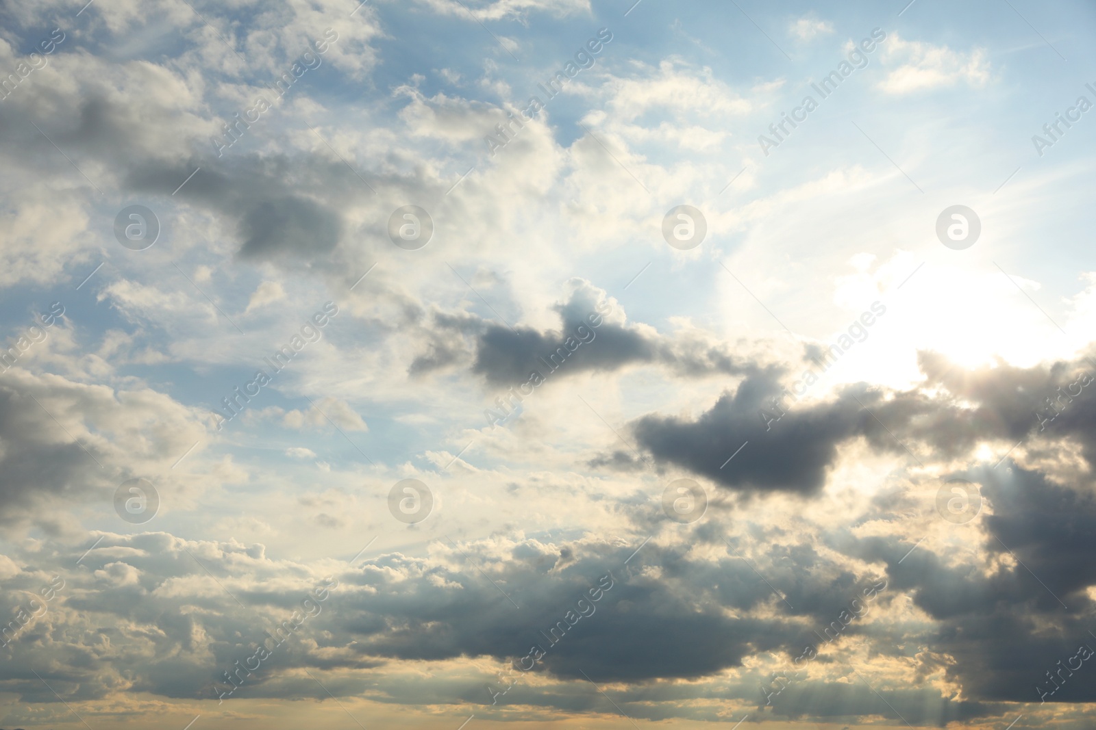 Photo of Sun shining through clouds on beautiful sky