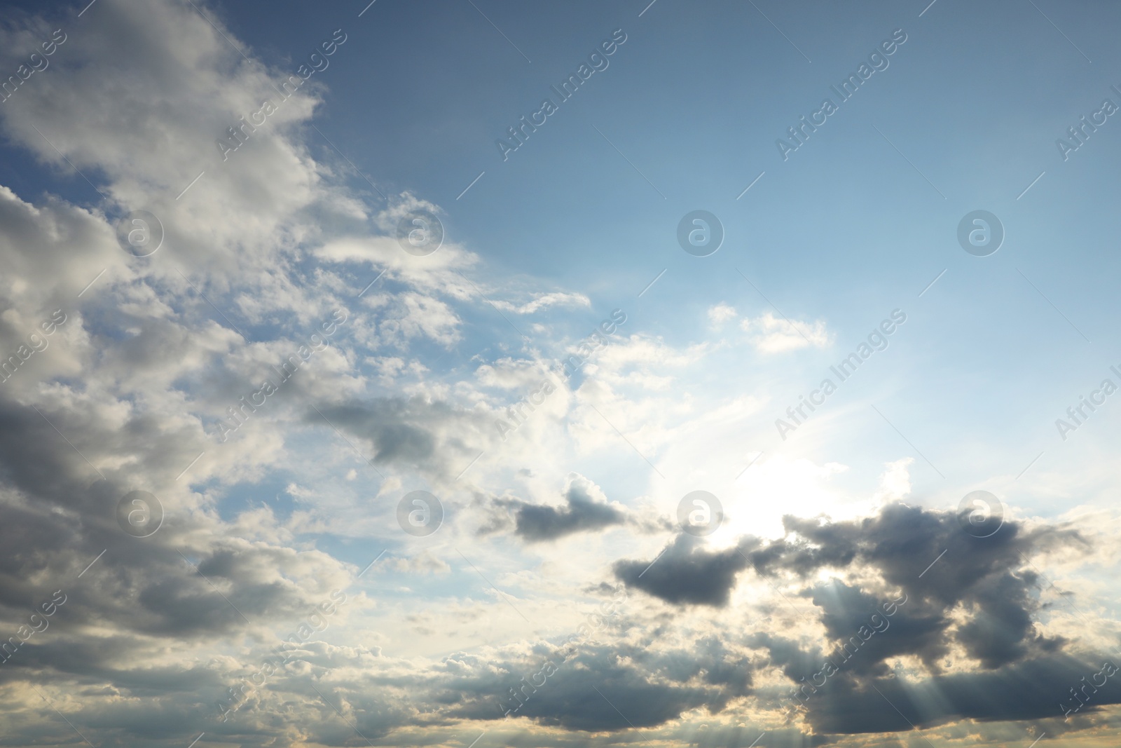 Photo of Sun shining through clouds on beautiful sky