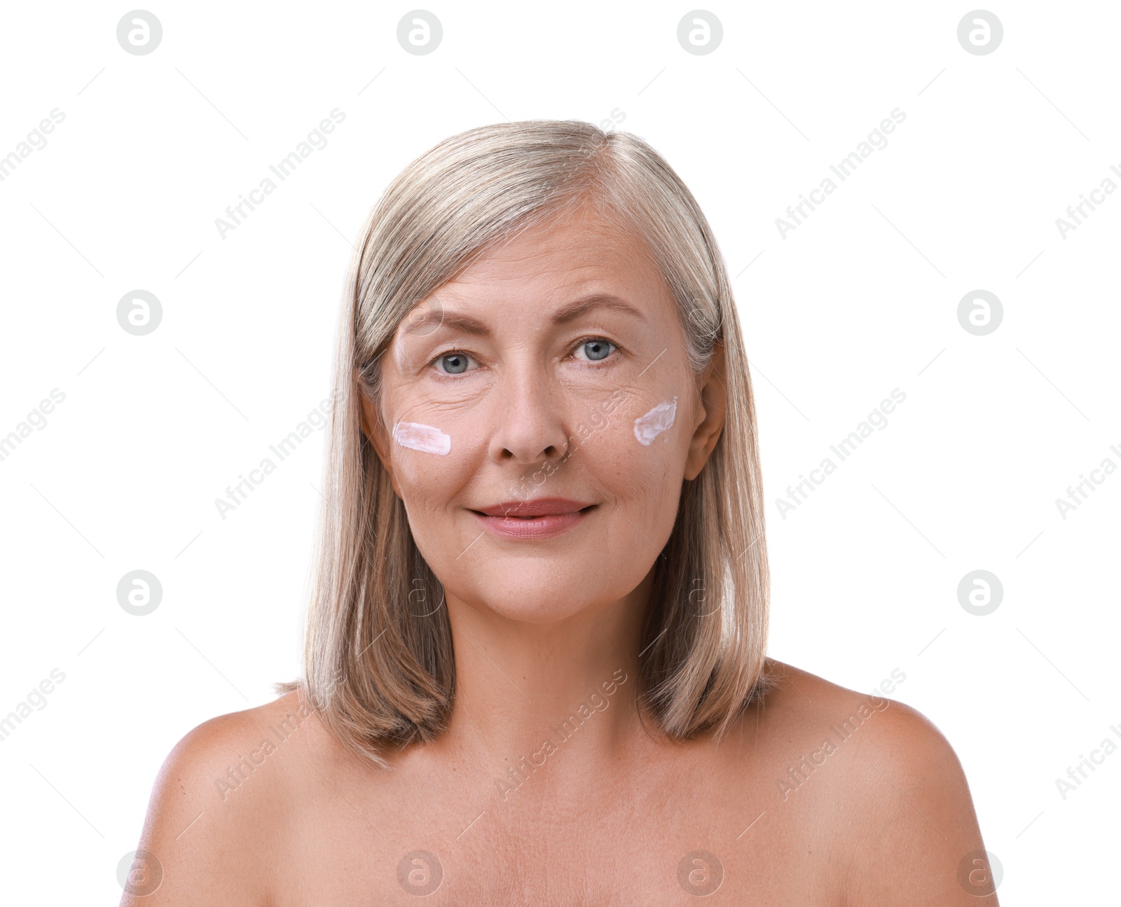 Photo of Senior woman with face cream on white background