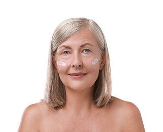 Senior woman with face cream on white background