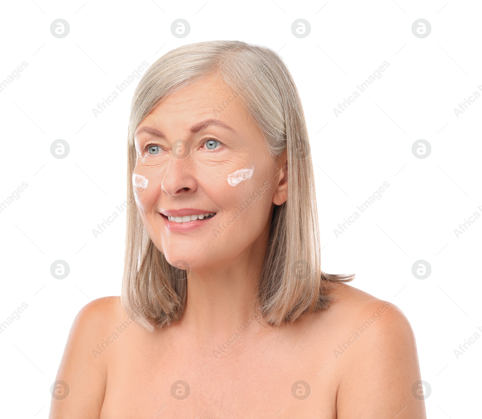 Photo of Senior woman with face cream on white background