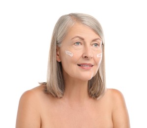 Senior woman with face cream on white background