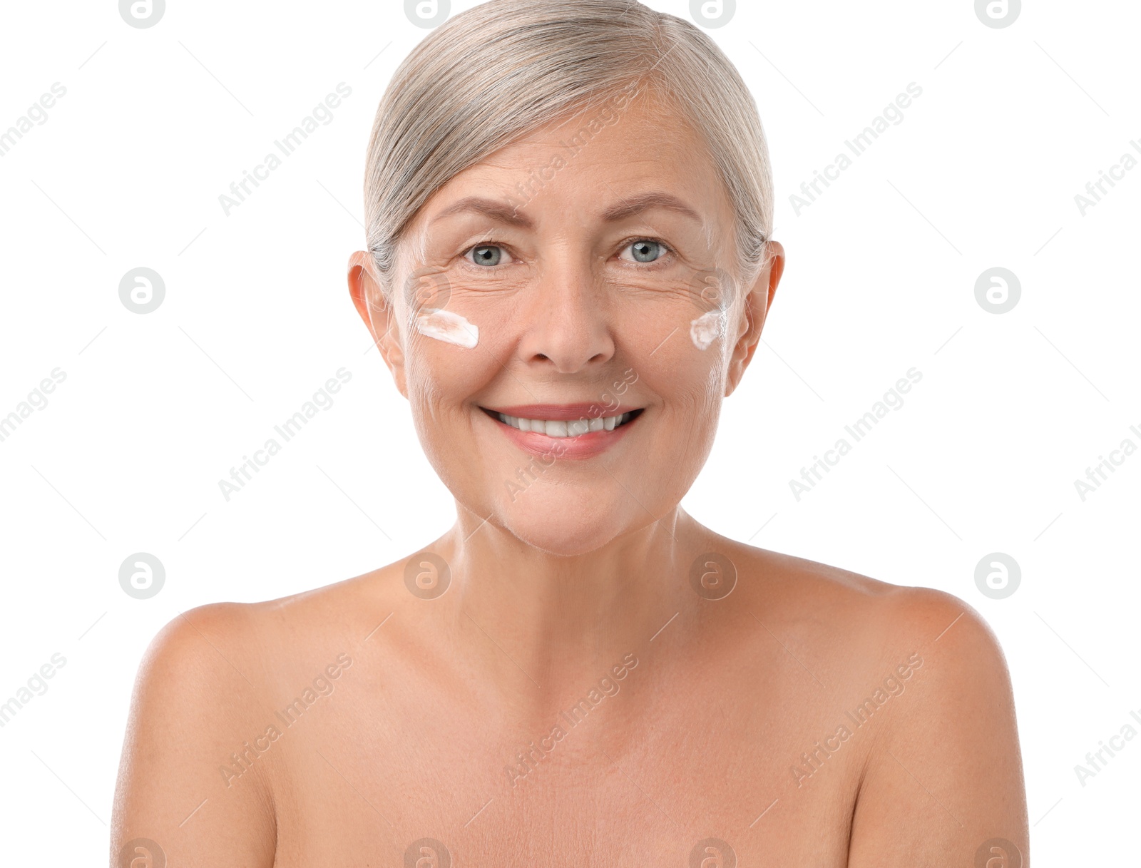 Photo of Senior woman with face cream on white background