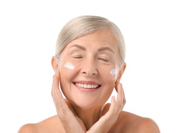 Senior woman with face cream on white background