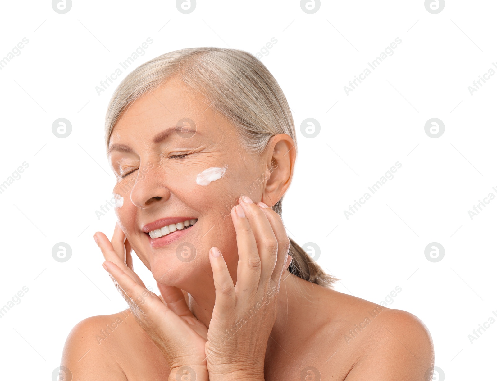 Photo of Senior woman with face cream on white background