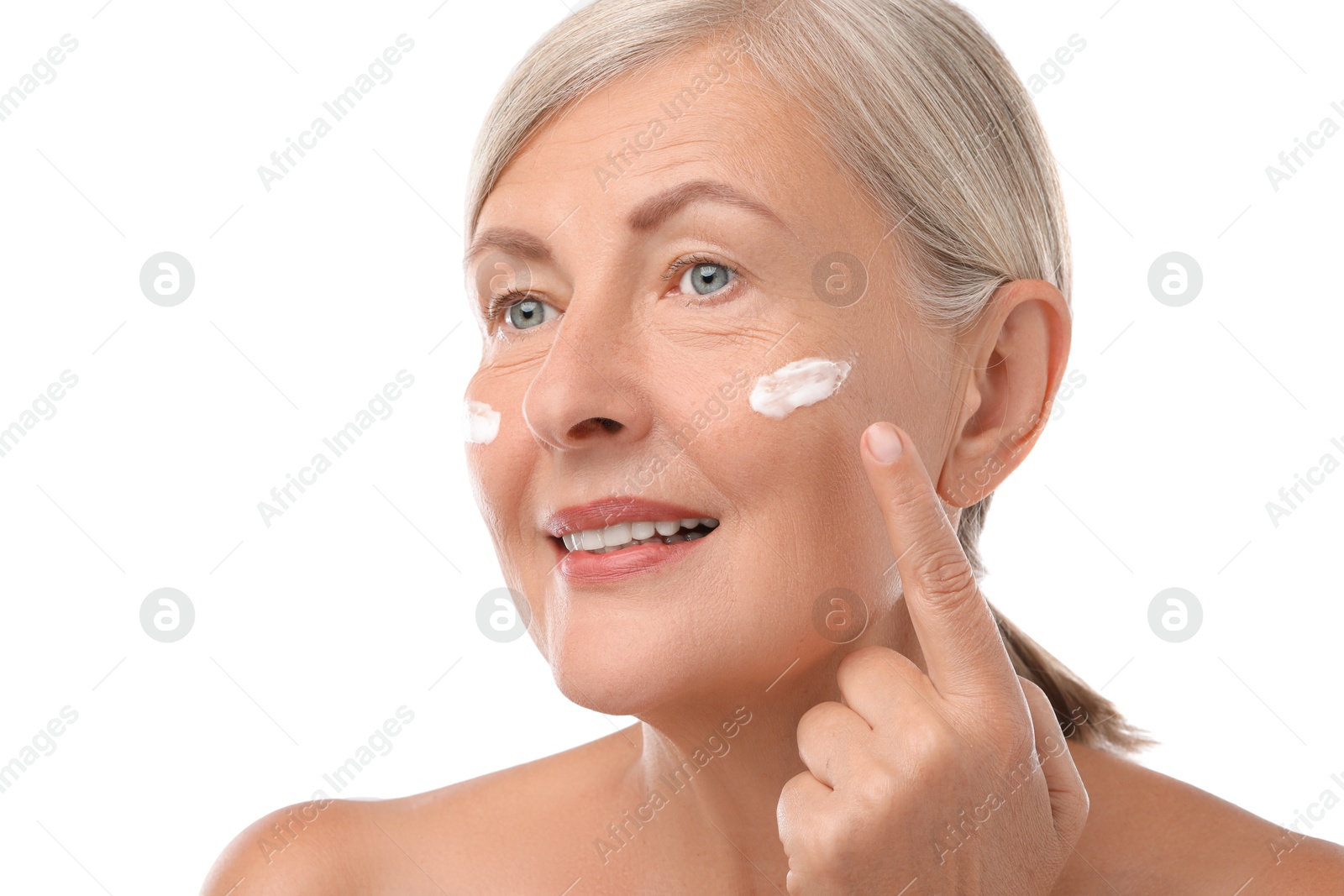 Photo of Senior woman with face cream on white background