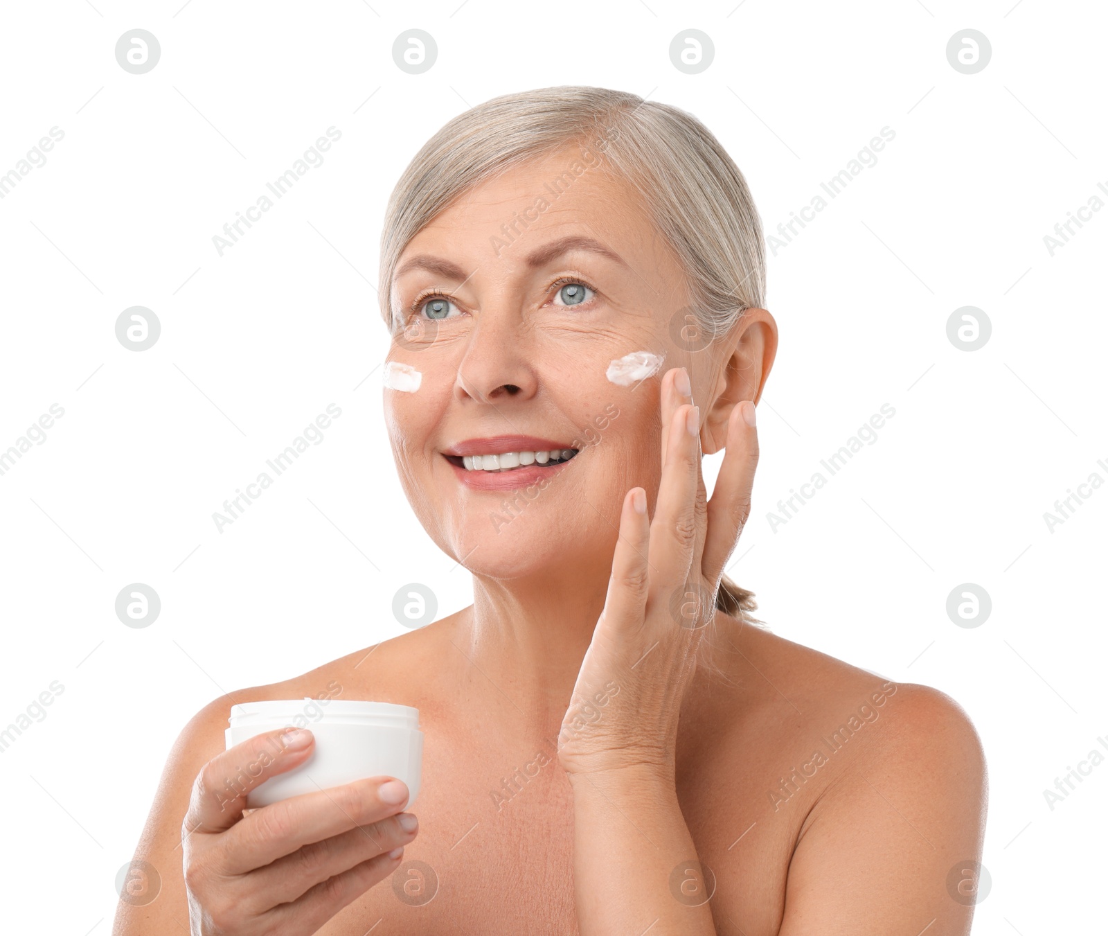 Photo of Senior woman applying face cream on white background