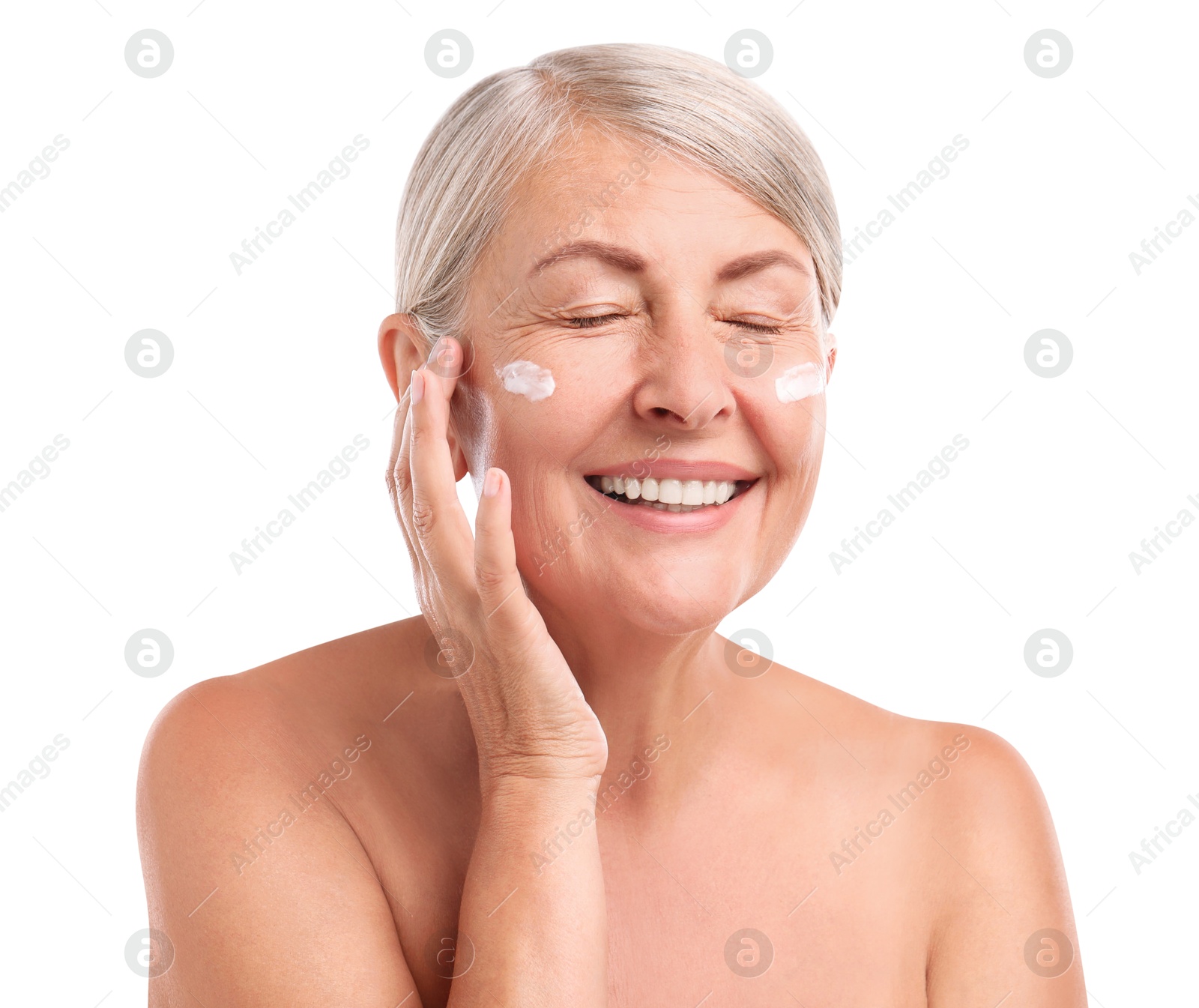 Photo of Senior woman with face cream on white background