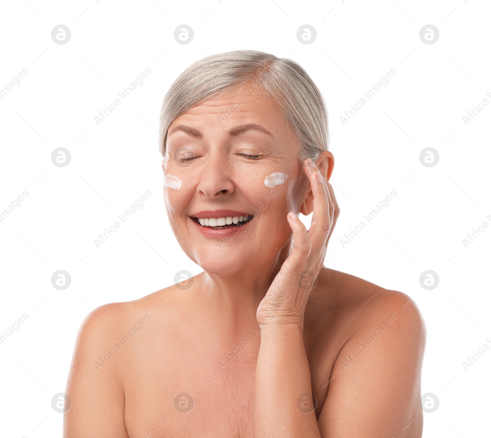 Photo of Senior woman with face cream on white background