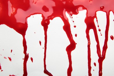 Photo of Leaking red blood stain on white background