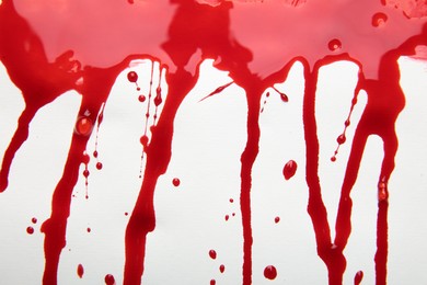 Photo of Leaking red blood stain on white background