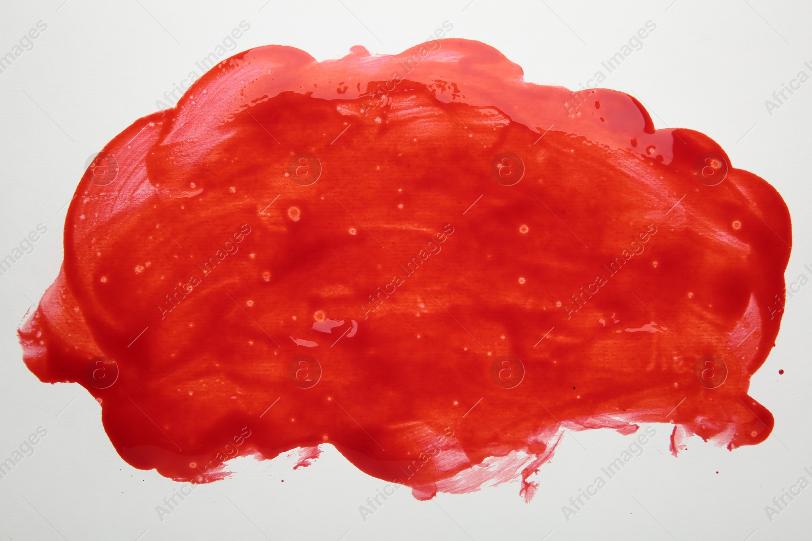 Photo of Stain of red blood on white background