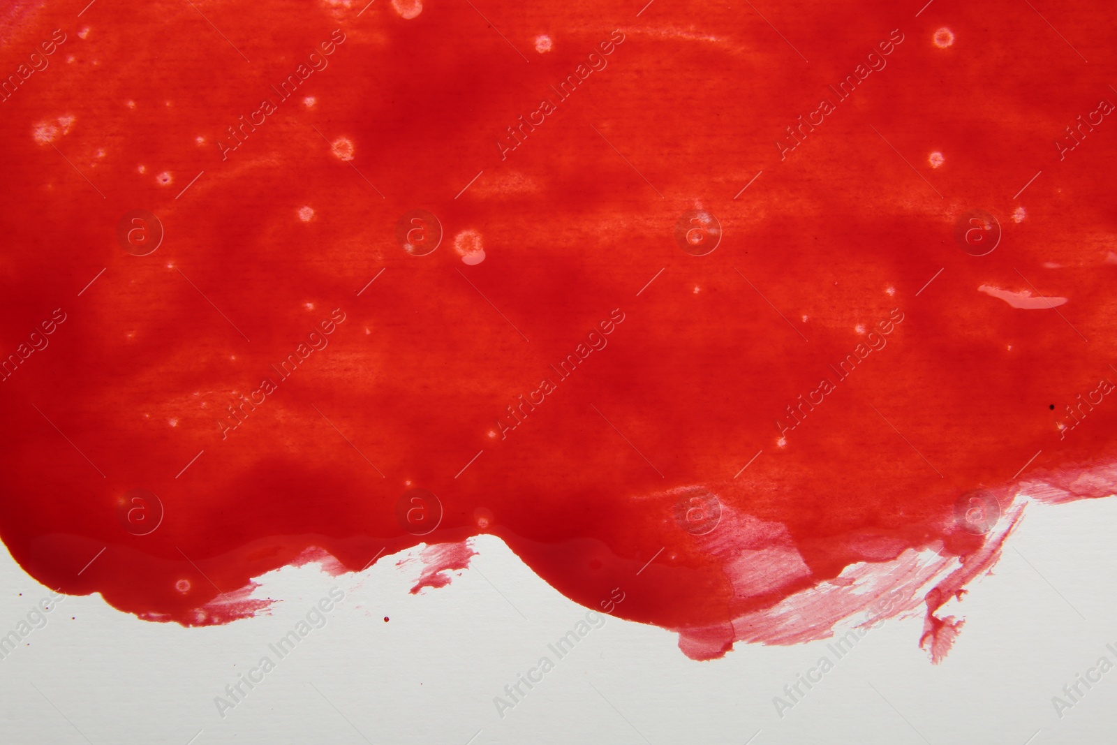 Photo of Stain of red blood on white background