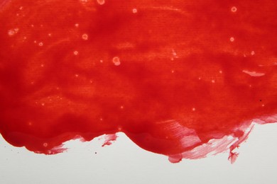 Photo of Stain of red blood on white background