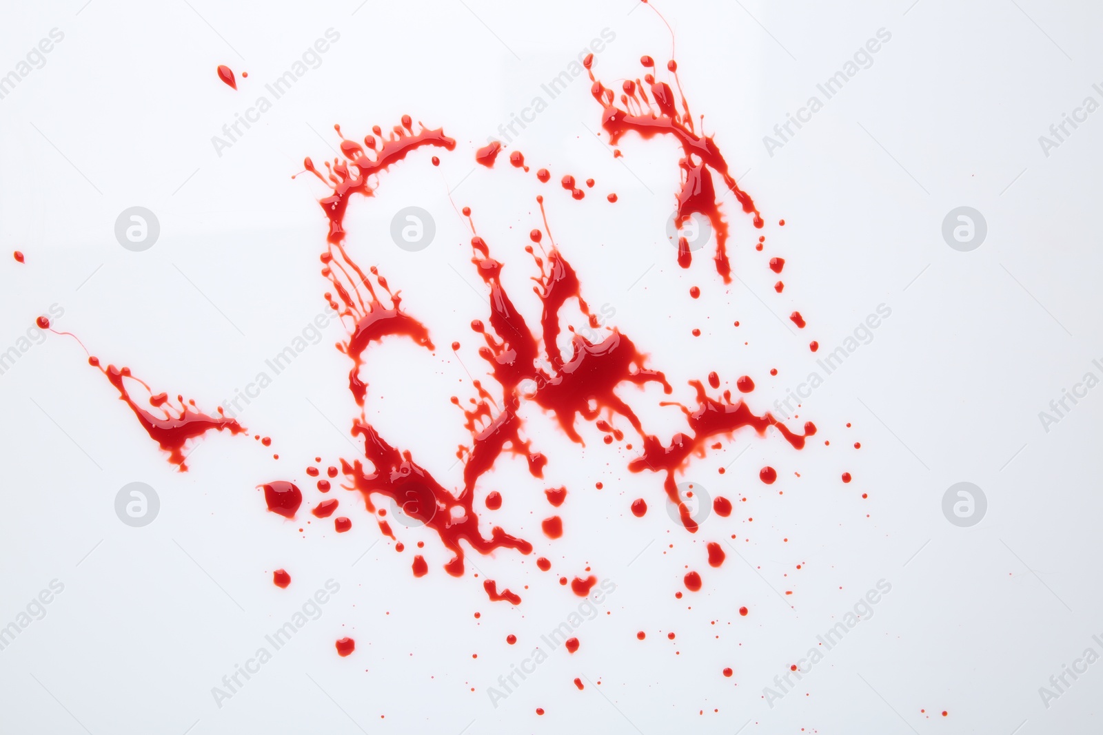 Photo of Splashes of red blood on white background