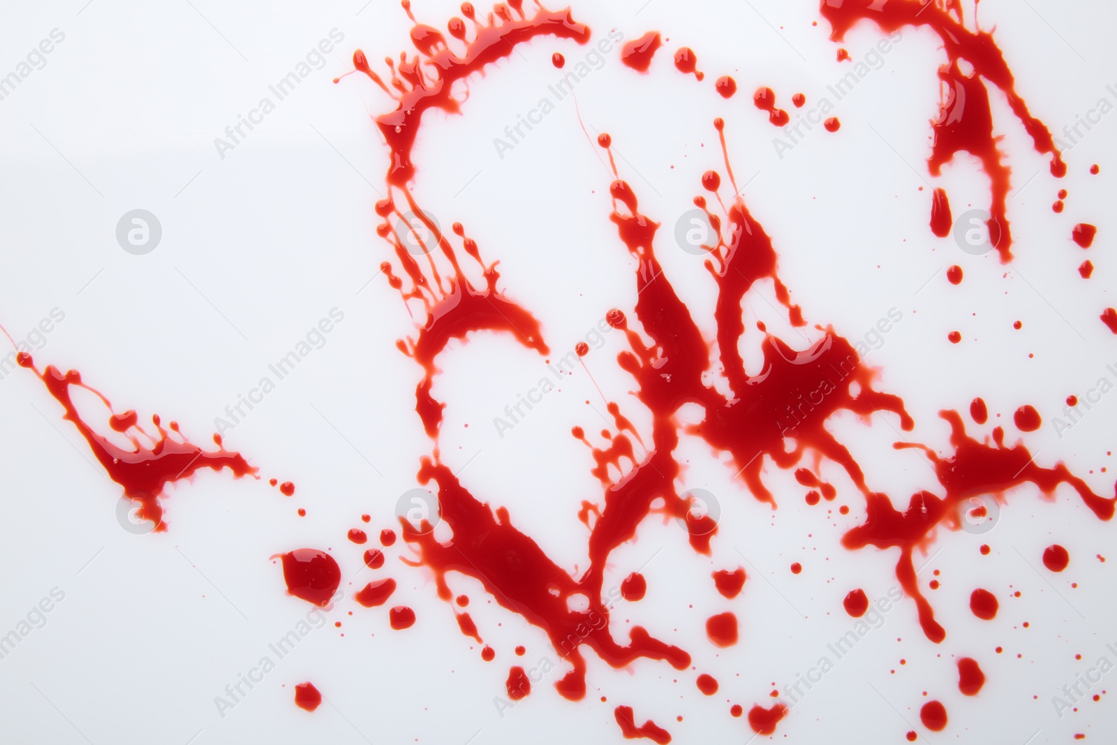 Photo of Splashes of red blood on white background