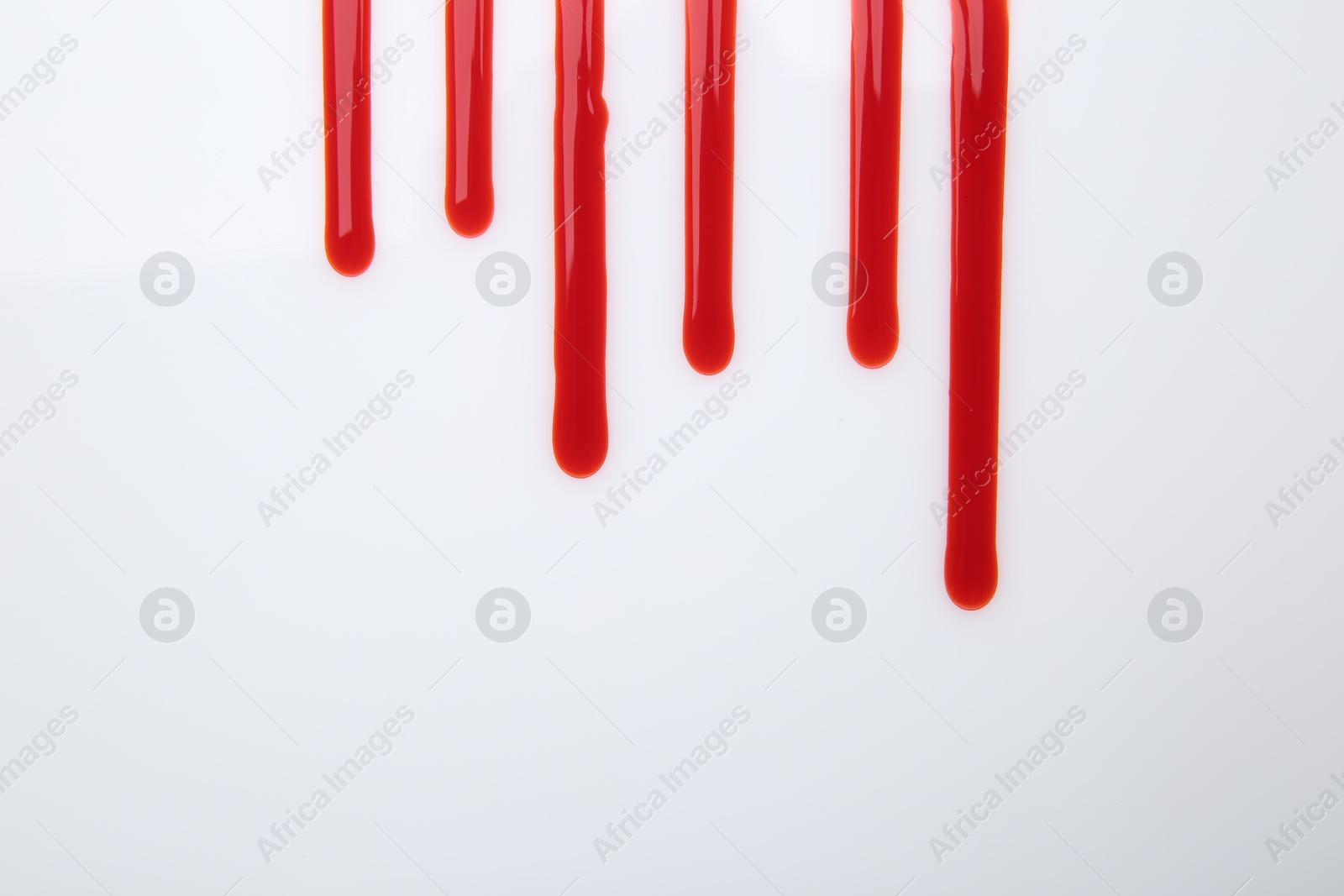 Photo of Leaking red blood stain on white background