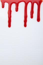 Photo of Leaking red blood stain on white background