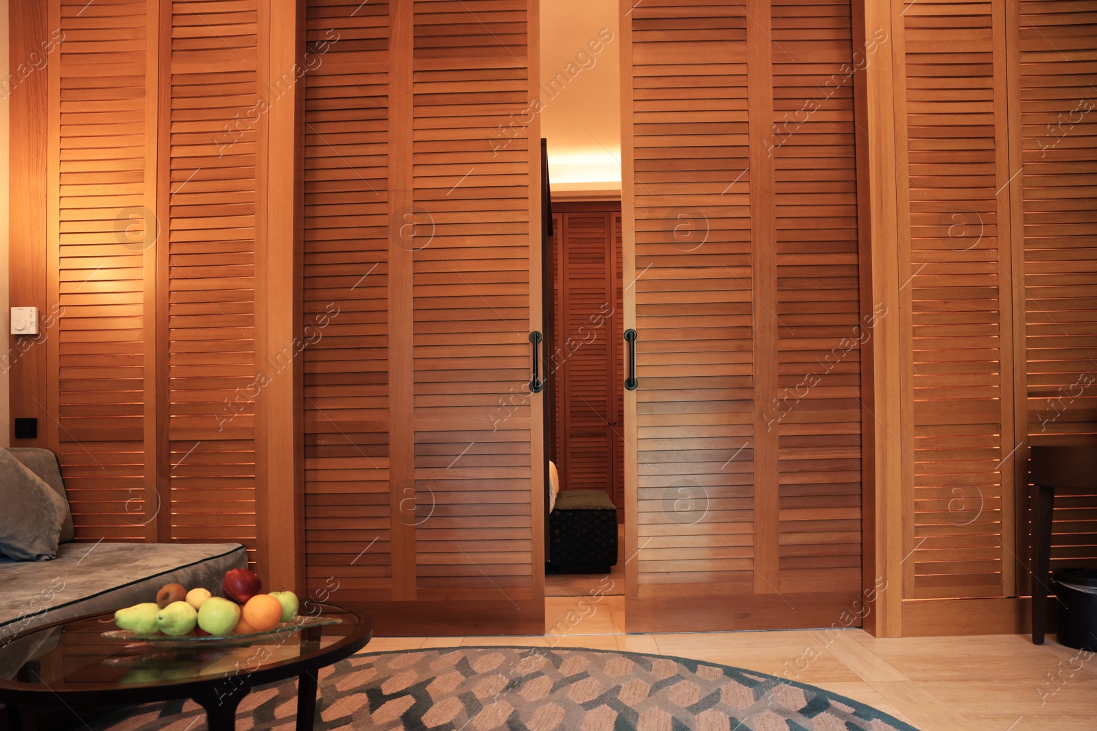 Photo of Stylish wooden sliding doors in hotel room