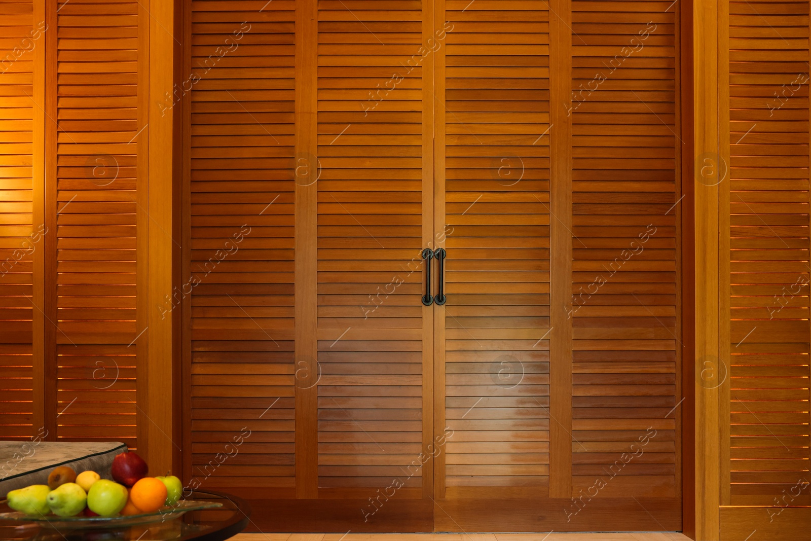 Photo of Stylish wooden sliding doors in hotel room