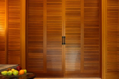 Photo of Stylish wooden sliding doors in hotel room