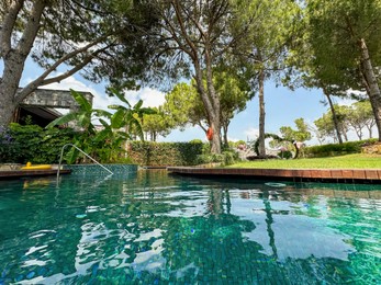 Photo of Outdoor swimming pool with clear water at luxury resort