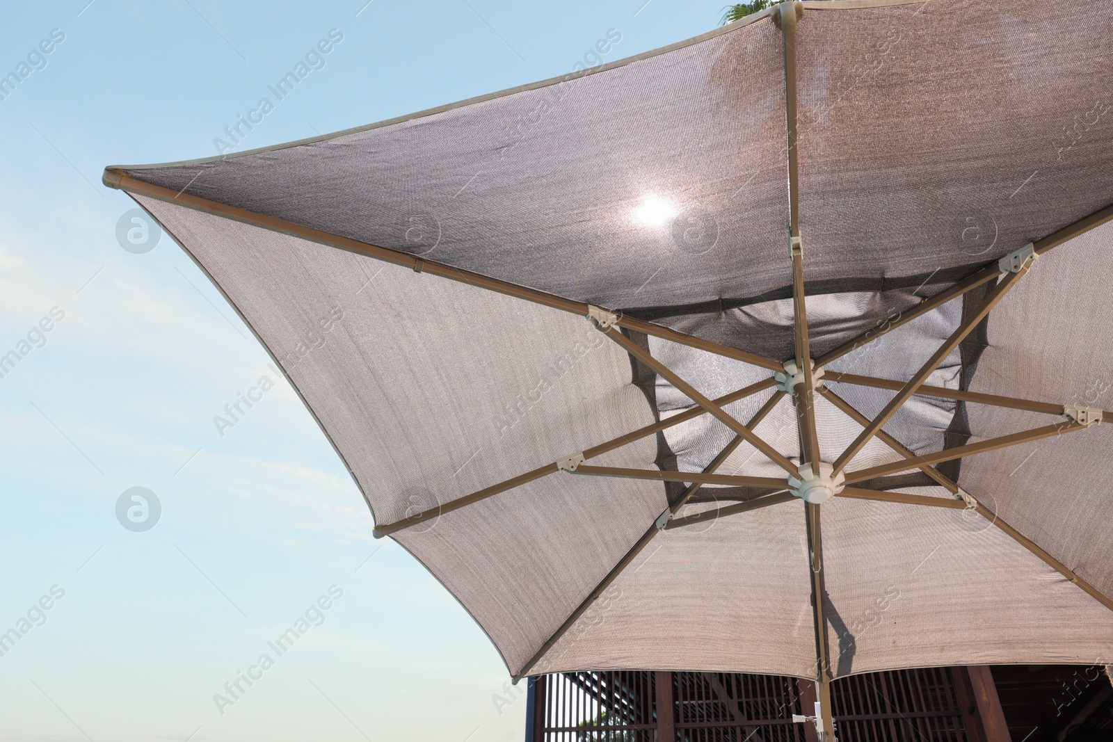 Photo of Open beach umbrella on sunny day, closeup