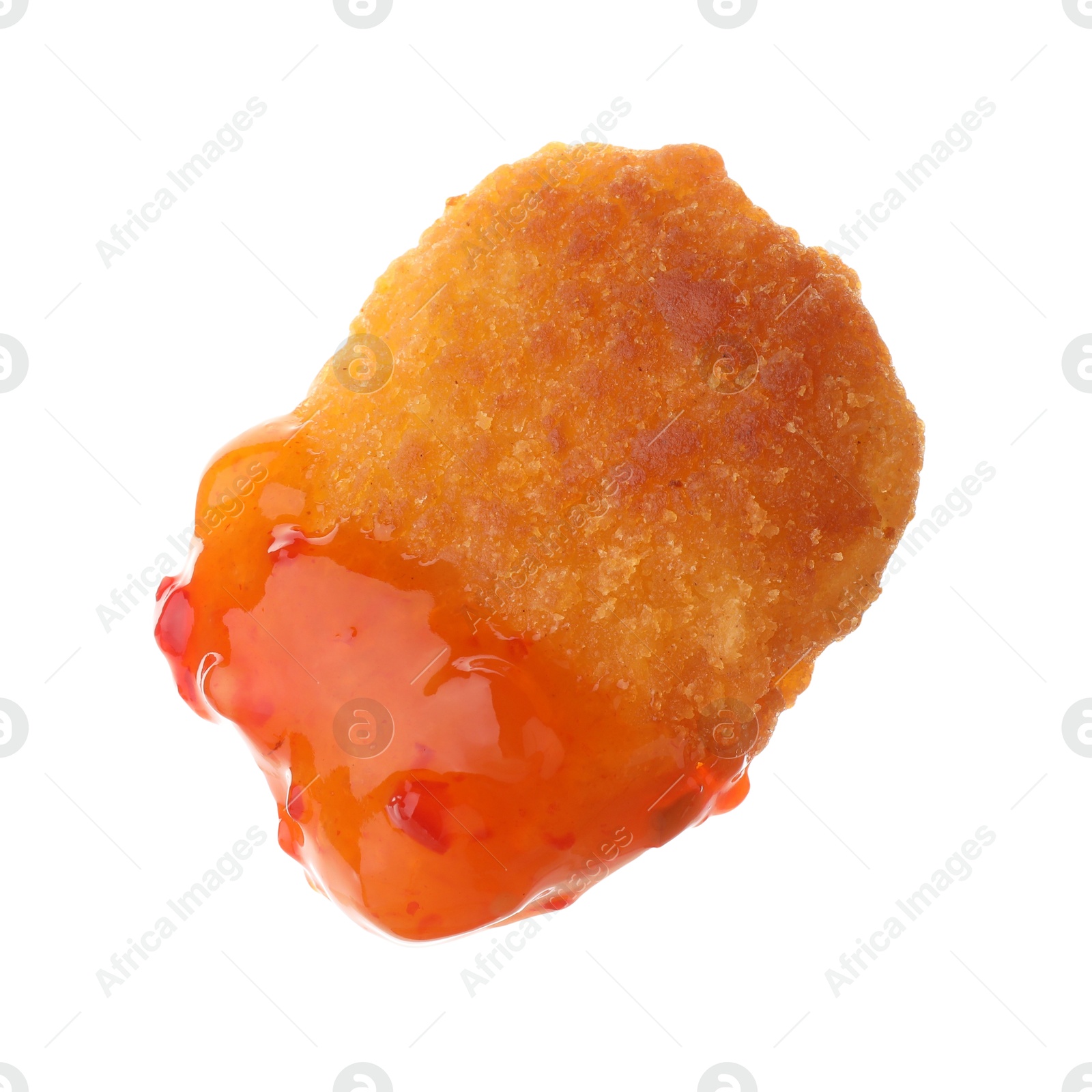 Photo of Tasty nugget dipped in hot chili sauce isolated on white