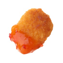 Photo of Tasty nugget dipped in hot chili sauce isolated on white