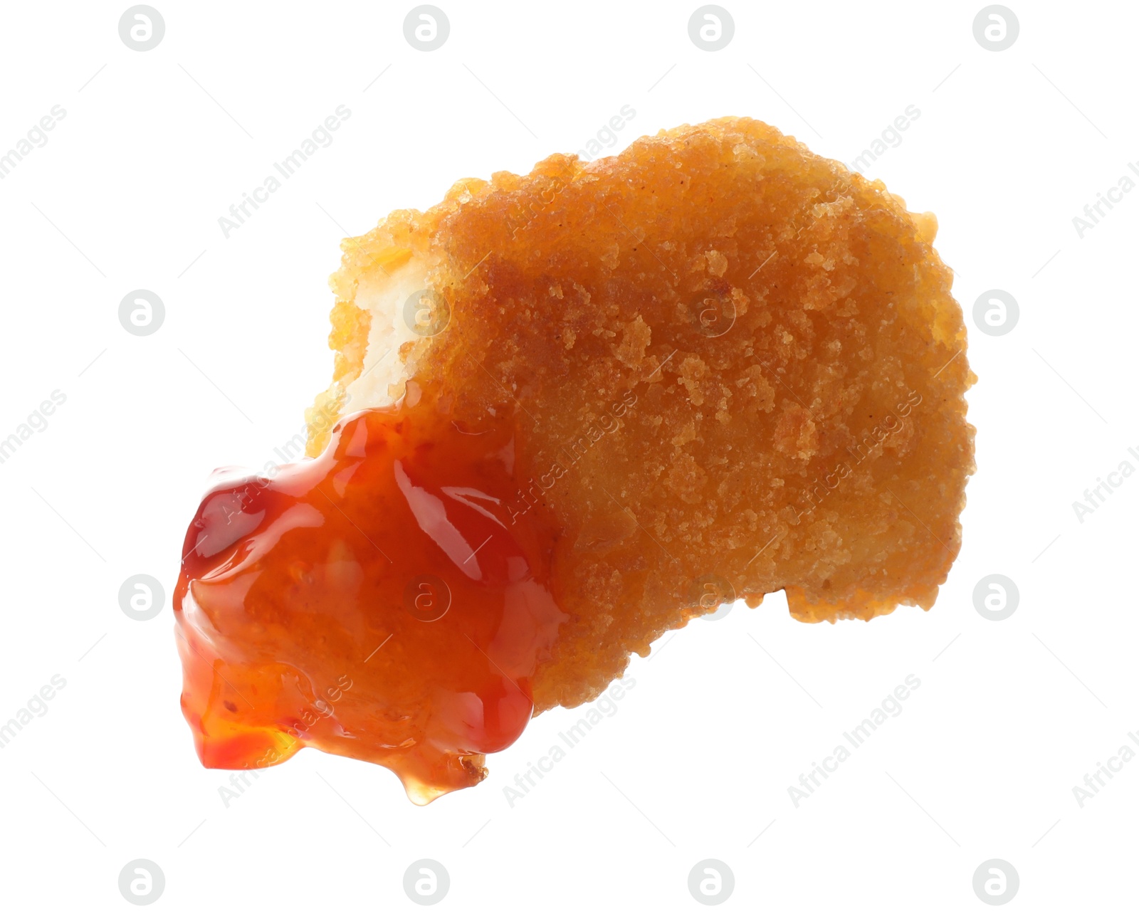 Photo of Tasty nugget dipped in hot chili sauce isolated on white