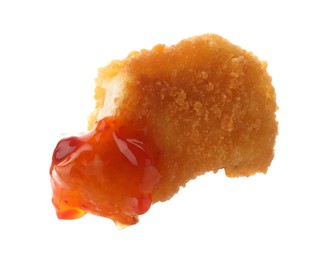 Photo of Tasty nugget dipped in hot chili sauce isolated on white