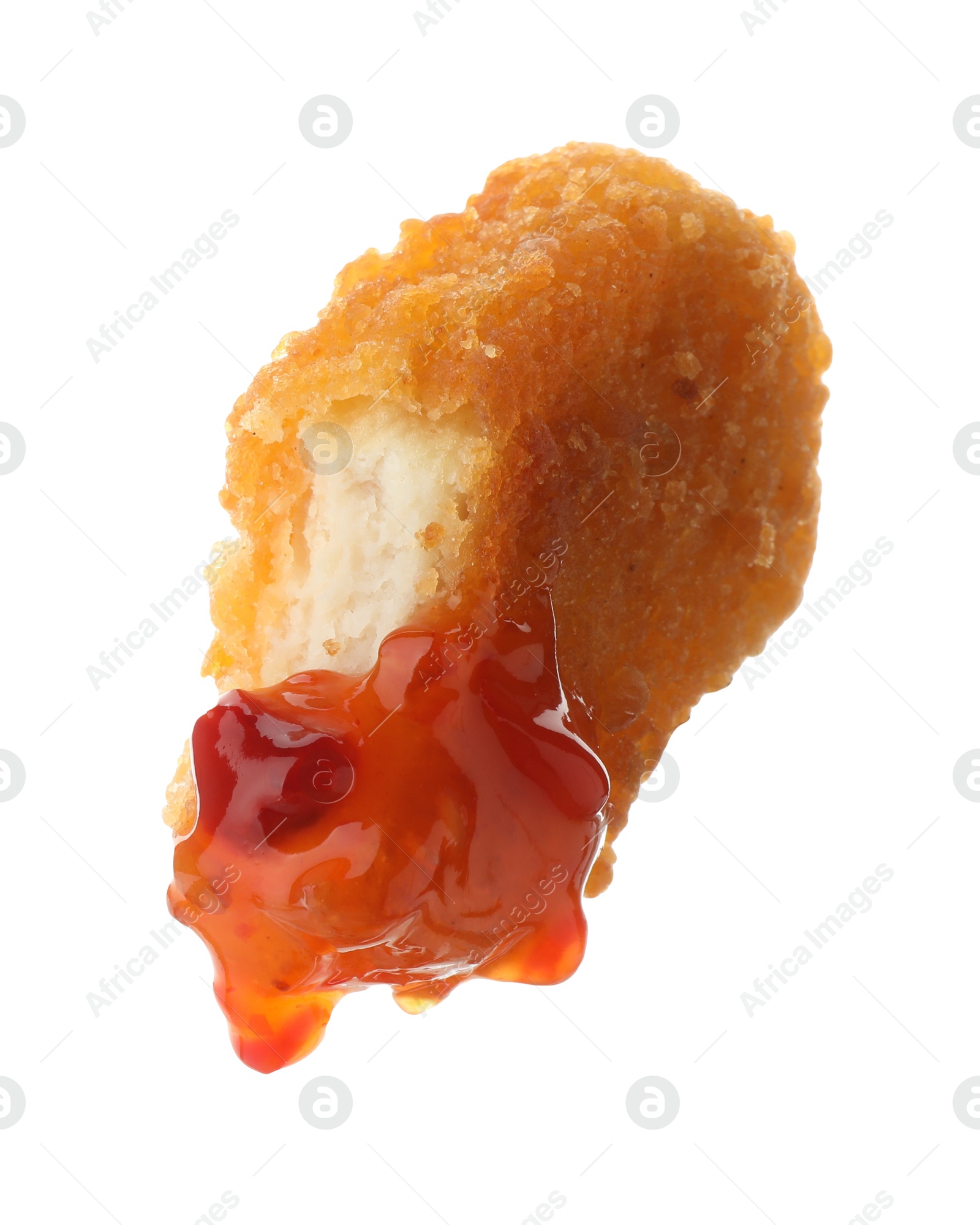 Photo of Tasty nugget dipped in hot chili sauce isolated on white