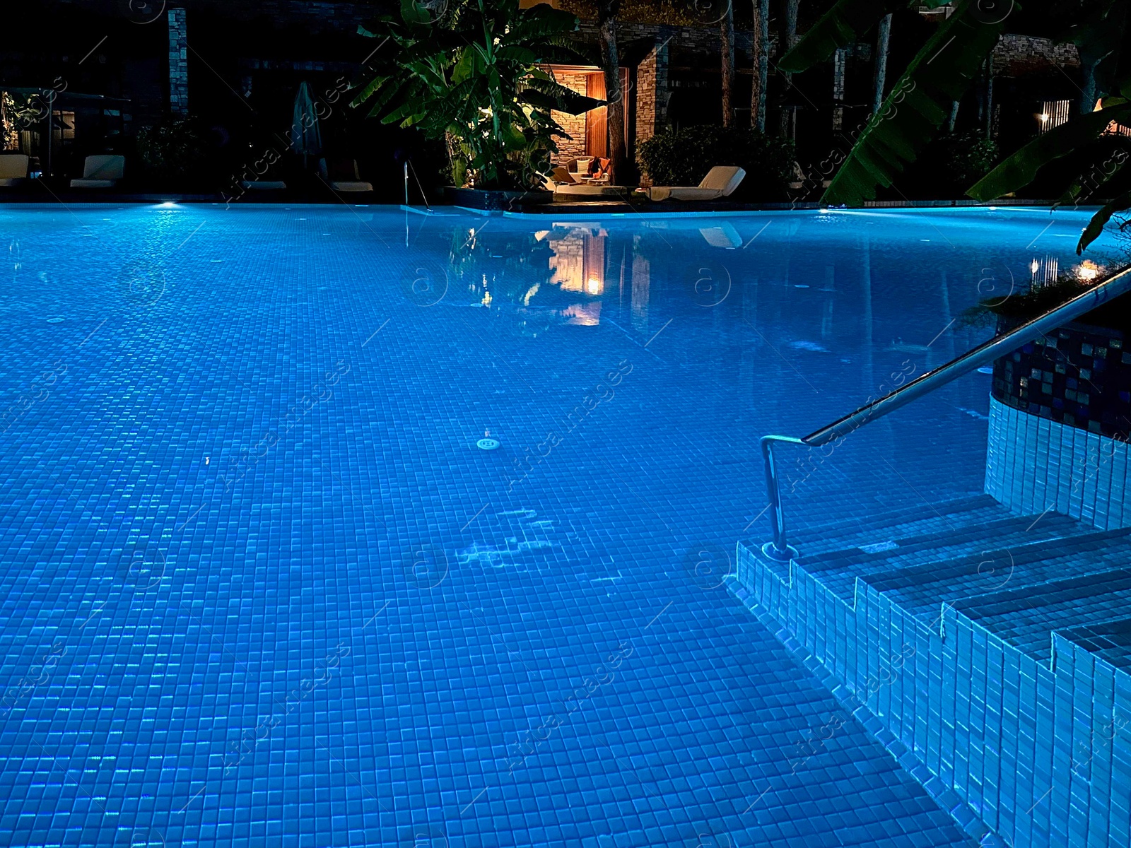 Photo of Beautiful view of swimming pool with clear water at night